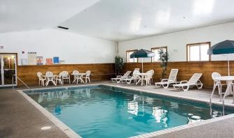 Indoor pool with pool chairs at Norwood Inn & Suites - Roseville.