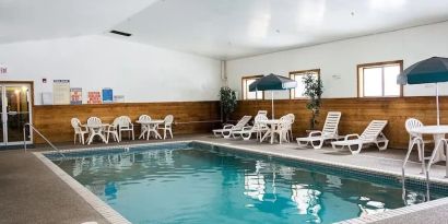 Indoor pool with pool chairs at Norwood Inn & Suites - Roseville.