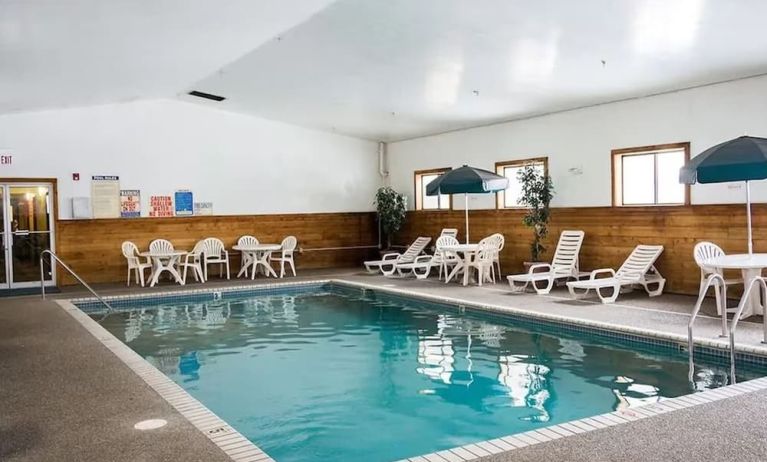 Indoor pool with pool chairs at Norwood Inn & Suites - Roseville.