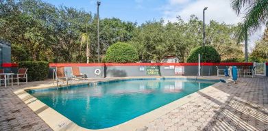 Relaxing outdoor pool at OYO Townhouse Orlando West.