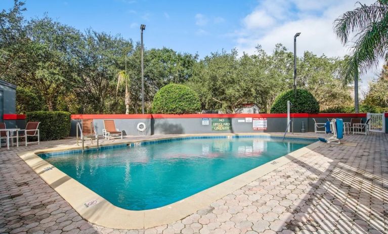 Relaxing outdoor pool at OYO Townhouse Orlando West.