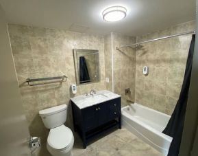 Private bathroom with shower at Hotel Liberty Inn & Suites.