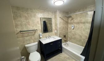 Private bathroom with shower at Hotel Liberty Inn & Suites.