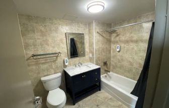 Private bathroom with shower at Hotel Liberty Inn & Suites.