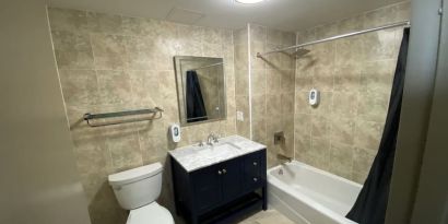 Private bathroom with shower at Hotel Liberty Inn & Suites.