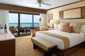 King bed with outdoor terrace at Ko'a Kea Resort On Po`ipu Beach.