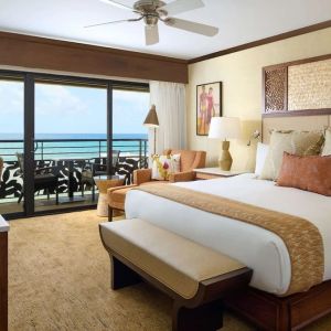 King bed with outdoor terrace at Ko'a Kea Resort On Po`ipu Beach.