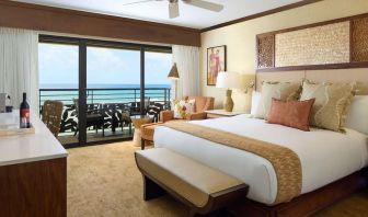 King bed with outdoor terrace at Ko'a Kea Resort On Po`ipu Beach.