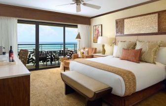 King bed with outdoor terrace at Ko'a Kea Resort On Po`ipu Beach.