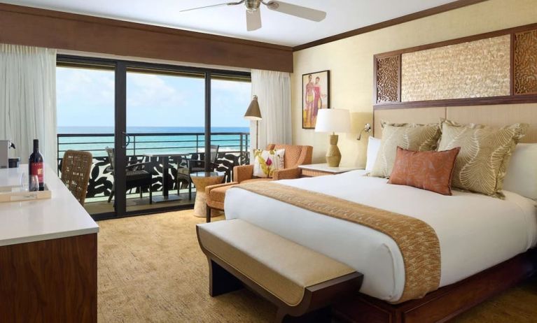 King bed with outdoor terrace at Ko'a Kea Resort On Po`ipu Beach.