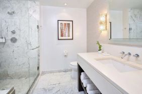 Bathroom with shower at Ko'a Kea Resort On Po`ipu Beach.