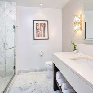 Bathroom with shower at Ko'a Kea Resort On Po`ipu Beach.