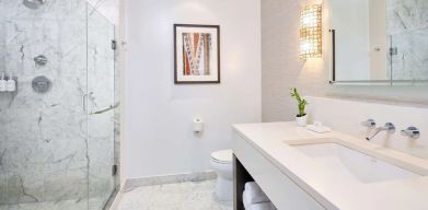 Bathroom with shower at Ko'a Kea Resort On Po`ipu Beach.