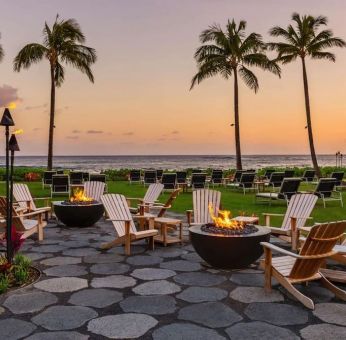 Garden with seating area ideal for coworking at Ko'a Kea Resort On Po`ipu Beach.