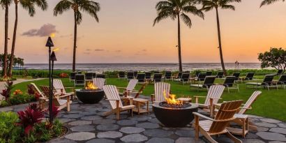 Garden with seating area ideal for coworking at Ko'a Kea Resort On Po`ipu Beach.