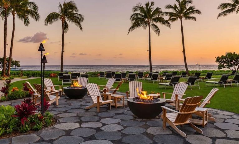 Garden with seating area ideal for coworking at Ko'a Kea Resort On Po`ipu Beach.