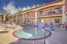 Relaxing pool area with loungers at Casa Rosa Inn.