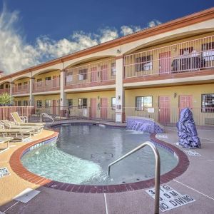 Relaxing pool area with loungers at Casa Rosa Inn.