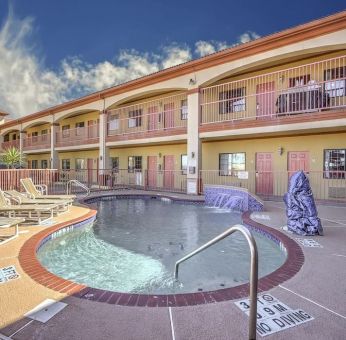 Relaxing pool area with loungers at Casa Rosa Inn.