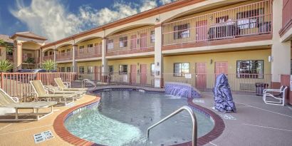 Relaxing pool area with loungers at Casa Rosa Inn.