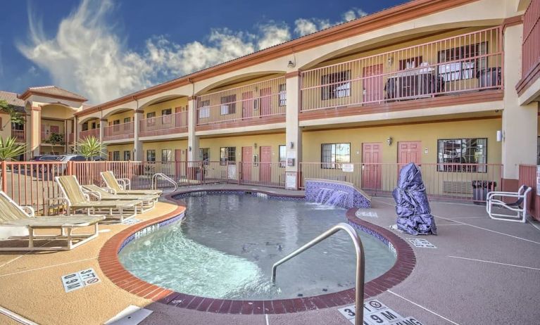 Relaxing pool area with loungers at Casa Rosa Inn.