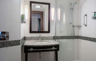 Guest bathroom with shower at Hampton By Hilton Birmingham Broad Street.