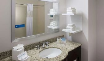 Guest bathroom with shower at Hampton Inn Los Angeles-Orange County-Cypress.