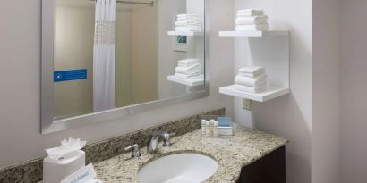 Guest bathroom with shower at Hampton Inn Los Angeles-Orange County-Cypress.