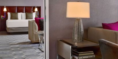 Deluxe king Royal Sonesta Houston Galleria guest room, furnished with coffee table, sofa, and chair.