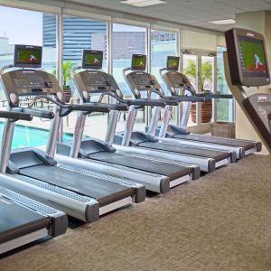 The hotel fitness center has numerous treadmills and other exercise machines, and faces the pool.