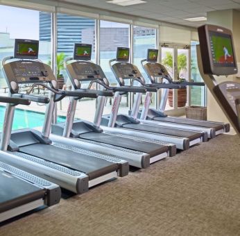 The hotel fitness center has numerous treadmills and other exercise machines, and faces the pool.