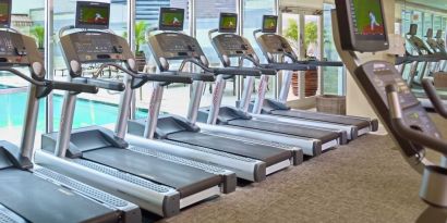 The hotel fitness center has numerous treadmills and other exercise machines, and faces the pool.