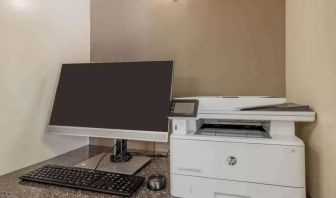 Hotel business center workstation, including monitor, keyboard, mouse, and printer.