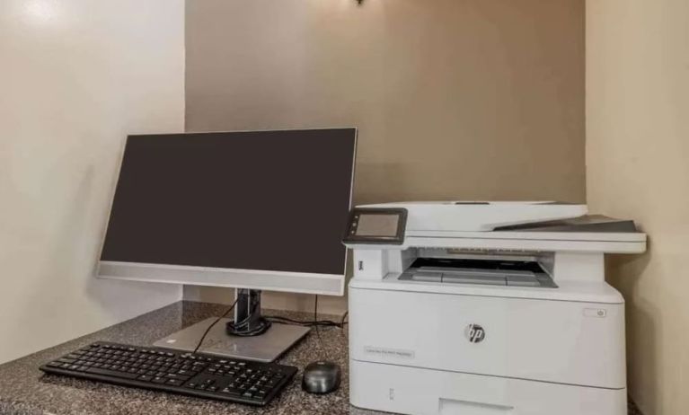 Hotel business center workstation, including monitor, keyboard, mouse, and printer.