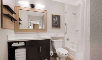 Sonesta Simply Suites Irvine East Foothill guest bathroom, including mirror, lavatory, sink, and bath with a shower.