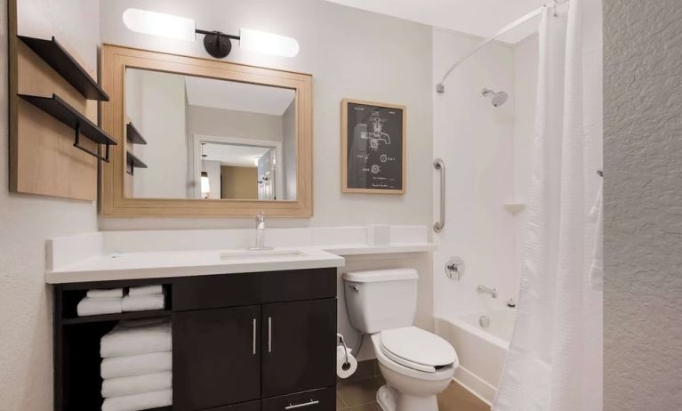 Sonesta Simply Suites Irvine East Foothill guest bathroom, including mirror, lavatory, sink, and bath with a shower.