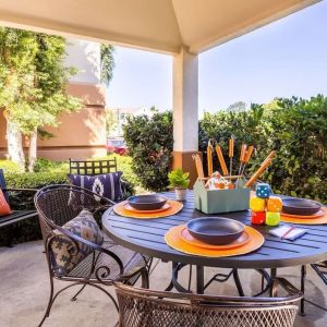 Sonesta Simply Suites Irvine East Foothill co-working space beneath a gazebo, featuring a round table and pleasant greenery.