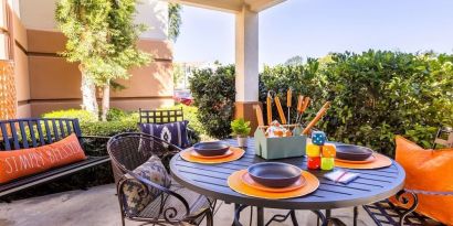 Sonesta Simply Suites Irvine East Foothill co-working space beneath a gazebo, featuring a round table and pleasant greenery.