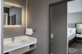 Sonesta Select Nashville Airport Suites double bed guest room, with ensuite bathroom.