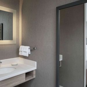 Sonesta Select Nashville Airport Suites double bed guest room, with ensuite bathroom.