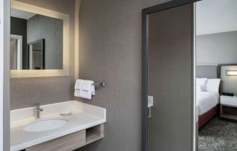 Sonesta Select Nashville Airport Suites double bed guest room, with ensuite bathroom.