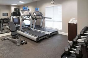 The hotel fitness center is equipped with racks of free weights plus treadmills.