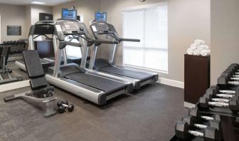 The hotel fitness center is equipped with racks of free weights plus treadmills.