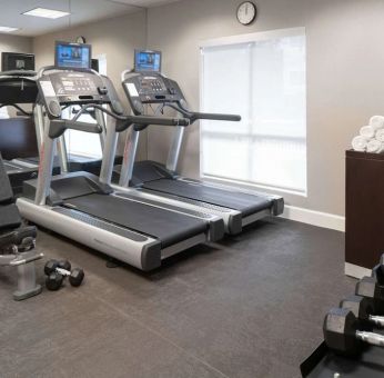 The hotel fitness center is equipped with racks of free weights plus treadmills.