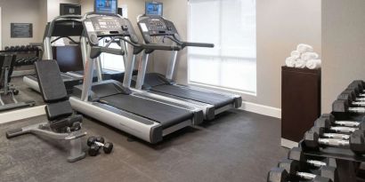 The hotel fitness center is equipped with racks of free weights plus treadmills.