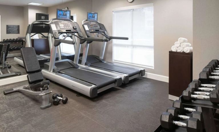 The hotel fitness center is equipped with racks of free weights plus treadmills.