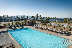 Stunning outdoor pool area with pool chairs at Sonesta Redondo Beach & Marina.