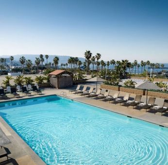 Stunning outdoor pool area with pool chairs at Sonesta Redondo Beach & Marina.