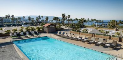 Stunning outdoor pool area with pool chairs at Sonesta Redondo Beach & Marina.