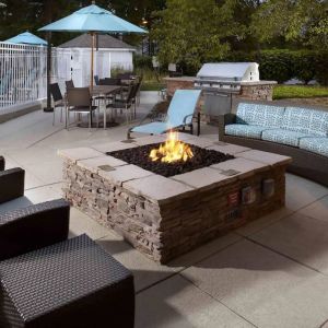 Sonesta ES Suites Cincinnati - Blue Ash’s patio area features a fire pit, plus tables and chairs, and a barbecue.